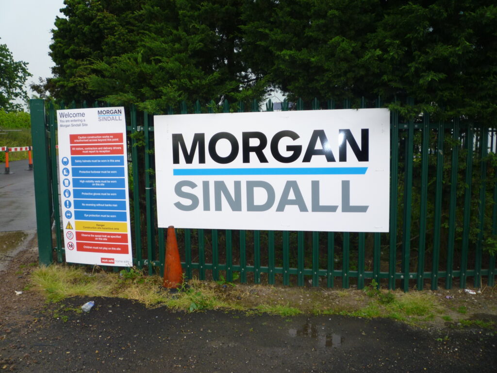 Entrance to a Morgan Sindall construction site with a large safety sign