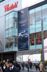 Exterior of Westfield shopping center with a DS Automobiles advertisement
