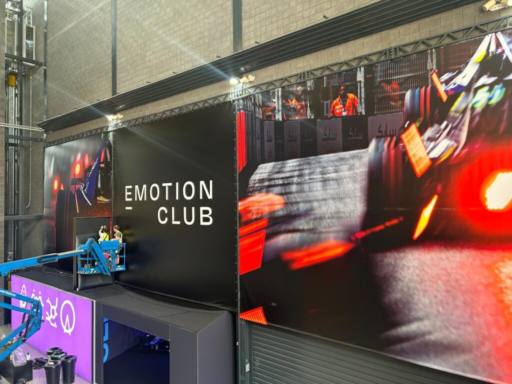 Large "Emotion Club" Formula E signage being installed.