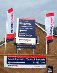 Wayfinding signage and flags for the Bloor Homes at Kingsway development, directing visitors to the Sales Centre.
