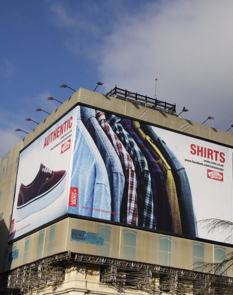 A Billboard advertising for vans designed by Hollywood Monster, featuring the iconic vans shoe and some shirts.