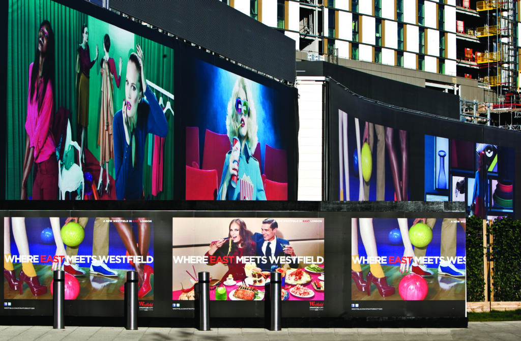 Westfield retail store signage for a Store Launch, hoarding across a building with a picture of a woman in a cinema